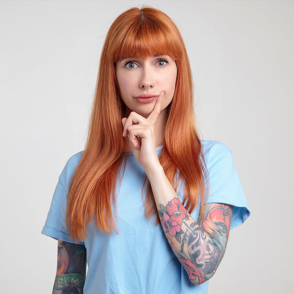 Woman looking confused with tattoos and piercings